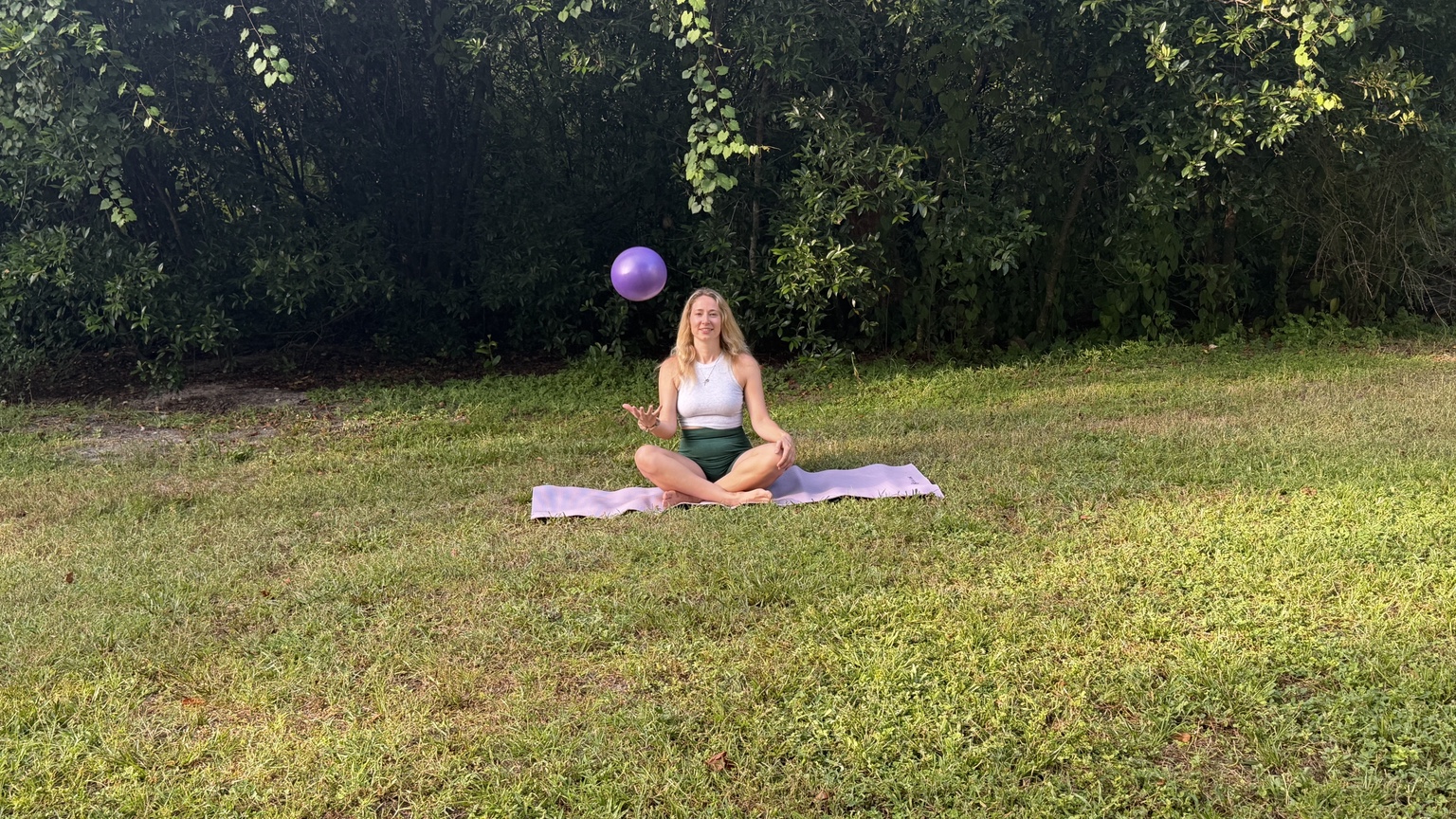 Outdoor Pilates with a purple ball